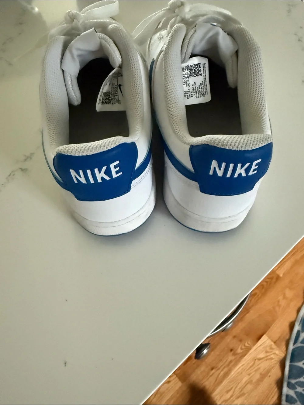 Nike White Sneakers with Blue Swoosh Accent
